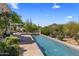 Inviting swimming pool with desert views and stone patio at 10420 E Morning Vista Ln, Scottsdale, AZ 85262