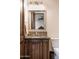 Bathroom vanity with dark cabinets, granite countertop, decorative backsplash, and mirror at 10922 E Purple Aster Way, Scottsdale, AZ 85262