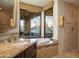 Bathroom featuring a granite countertop vanity, a soaking tub, and a shower at 10922 E Purple Aster Way, Scottsdale, AZ 85262