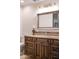 Bathroom boasts a wood vanity with light countertop and a decorative backsplash at 10922 E Purple Aster Way, Scottsdale, AZ 85262