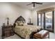 Comfortable bedroom featuring a ceiling fan and a sliding glass door to the backyard at 10922 E Purple Aster Way, Scottsdale, AZ 85262