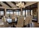 Bright dining room featuring a large dining table, coffered ceiling, and scenic outdoor views at 10922 E Purple Aster Way, Scottsdale, AZ 85262