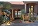 Elegant front entrance with stone accents and desert landscaping creates curb appeal at 10922 E Purple Aster Way, Scottsdale, AZ 85262
