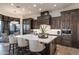 Open concept kitchen with a large marble island, custom cabinets, and stainless steel appliances at 10922 E Purple Aster Way, Scottsdale, AZ 85262