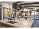 Spacious kitchen with stone countertops, wood beam ceilings, and an open view to the living space at 10922 E Purple Aster Way, Scottsdale, AZ 85262