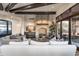 Elegant living room with stone fireplace, wood beam ceilings and seamless access to outdoor living at 10922 E Purple Aster Way, Scottsdale, AZ 85262