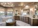 Bright main bath features a modern soaking tub, vanity with dark wood cabinets and marble countertops at 10922 E Purple Aster Way, Scottsdale, AZ 85262