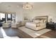 Bright main bedroom features elegant lighting, sitting area with a view, and hardwood flooring at 10922 E Purple Aster Way, Scottsdale, AZ 85262