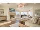 The elegant main bedroom features a stone fireplace, TV, and access to an outdoor sitting area at 10922 E Purple Aster Way, Scottsdale, AZ 85262