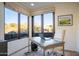 Bright office with golf course views and a large wooden desk at 10922 E Purple Aster Way, Scottsdale, AZ 85262