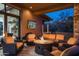 Comfortable outdoor seating area with a fire pit and mounted TV for relaxing evenings at 10922 E Purple Aster Way, Scottsdale, AZ 85262