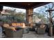 Comfortable outdoor seating area with a circular fire pit and views of natural desert landscape at 10922 E Purple Aster Way, Scottsdale, AZ 85262