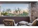 This home includes a covered outdoor patio with comfortable seating and desert views at 10922 E Purple Aster Way, Scottsdale, AZ 85262