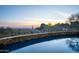 The pool reflects the sunset over the mountains at 10922 E Purple Aster Way, Scottsdale, AZ 85262