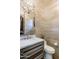Modern powder room with custom vanity, decorative lighting, and textured wall coverings at 10922 E Purple Aster Way, Scottsdale, AZ 85262