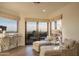 The bright sitting area features elegant furnishings, access to a patio, and amazing mountain views at 10922 E Purple Aster Way, Scottsdale, AZ 85262