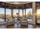 Cozy sitting area with floor to ceiling windows offering panoramic views of the desert landscape at 10922 E Purple Aster Way, Scottsdale, AZ 85262