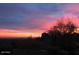 Captivating sunset view silhouettes desert landscape and distant mountains in vibrant hues at 10922 E Purple Aster Way, Scottsdale, AZ 85262