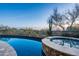 Beautiful swimming pool and spa surrounded by natural desert landscaping at 10922 E Purple Aster Way, Scottsdale, AZ 85262