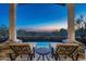 Inviting swimming pool framed by stately columns offers stunning desert views at sunset at 10922 E Purple Aster Way, Scottsdale, AZ 85262