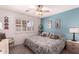 Bedroom with a king-size bed, ceiling fan, and window shutters at 11035 E Nopal Ave, Mesa, AZ 85209