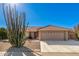 Tan house with cacti and a two-car garage at 11035 E Nopal Ave, Mesa, AZ 85209