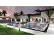 The backyard pool is surrounded by lush greenery, modern lighting, and ample lounging space at 11612 N 86Th St, Scottsdale, AZ 85260