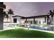 Enjoy the backyard pool surrounded by modern lighting, manicured lawn, and swaying palm trees at 11612 N 86Th St, Scottsdale, AZ 85260