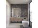 Stylish bathroom featuring a floating vanity, modern tub, and unique brick accent wall at 11612 N 86Th St, Scottsdale, AZ 85260