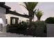 The home has well-maintained landscaping, black trimmed windows, and modern lighting at 11612 N 86Th St, Scottsdale, AZ 85260