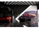 Luxury garage featuring 3 exotic sports cars, modern lighting and black marble floors at 11612 N 86Th St, Scottsdale, AZ 85260