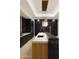 Modern kitchen with sleek black cabinets, a marble island, stainless steel appliances, and stylish pendant lighting at 11612 N 86Th St, Scottsdale, AZ 85260