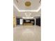 Spacious kitchen with marble floors, a large island, custom lighting, and modern black cabinetry at 11612 N 86Th St, Scottsdale, AZ 85260