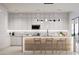 Contemporary kitchen with white cabinetry, marble counters, and modern appliances at 11612 N 86Th St, Scottsdale, AZ 85260