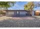 Gray back house with brick patio and wood fence at 12023 N 113Th Ave, Youngtown, AZ 85363