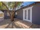 Back house exterior with double doors and gray brick at 12023 N 113Th Ave, Youngtown, AZ 85363