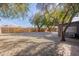 Large backyard with gravel landscaping and a wood fence at 12023 N 113Th Ave, Youngtown, AZ 85363