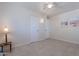 Bright bedroom with tile floors, double closets, and beach-themed art at 12023 N 113Th Ave, Youngtown, AZ 85363