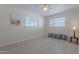 Cozy bedroom with tile floors, white brick walls, and a ceiling fan at 12023 N 113Th Ave, Youngtown, AZ 85363
