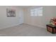 Charming bedroom with tile floors, a window, and floral artwork at 12023 N 113Th Ave, Youngtown, AZ 85363