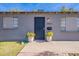 Gray house with black front door and two matching planters at 12023 N 113Th Ave, Youngtown, AZ 85363