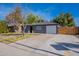 Cute bungalow with gray exterior, white garage door, and a brick walkway at 12023 N 113Th Ave, Youngtown, AZ 85363