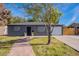 Gray house with a brick walkway leading to the front door and a white garage at 12023 N 113Th Ave, Youngtown, AZ 85363