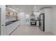 Updated kitchen with white cabinets, stainless steel appliances, and tile floor at 12023 N 113Th Ave, Youngtown, AZ 85363