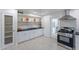 Modern kitchen with white shaker cabinets and stainless steel appliances at 12023 N 113Th Ave, Youngtown, AZ 85363