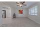 Living room with large window, tile floors, and ceiling fan at 12023 N 113Th Ave, Youngtown, AZ 85363