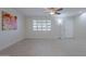 Living room with white brick walls, tile floors, and a ceiling fan at 12023 N 113Th Ave, Youngtown, AZ 85363