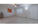 Bright living room with white brick walls, tile floors, and a ceiling fan at 12023 N 113Th Ave, Youngtown, AZ 85363