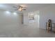 Bright living room features tile flooring and a ceiling fan at 12023 N 113Th Ave, Youngtown, AZ 85363