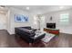 Modern living room with L-shaped sofa and hardwood floors at 1263 E Brookwood Ct, Phoenix, AZ 85048